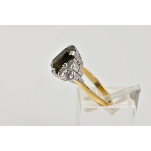 254 - AN 18CT GOLD TOURMALINE AND DIAMOND DRESS RING, centring on an emerald cut green tourmaline, flanked... 