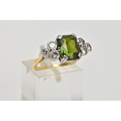 254 - AN 18CT GOLD TOURMALINE AND DIAMOND DRESS RING, centring on an emerald cut green tourmaline, flanked... 