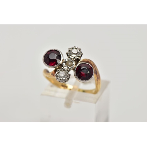 256 - AN EARLY 20TH CENTURY 18CT GOLD GARNET AND DIAMOND DRESS RING, of a cross over design, the centre pi... 