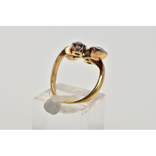 256 - AN EARLY 20TH CENTURY 18CT GOLD GARNET AND DIAMOND DRESS RING, of a cross over design, the centre pi... 