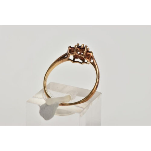 269 - A 9CT GOLD GARNET CLUSTER RING, flower shape cluster set with circular cut garnets, tapered shoulder... 