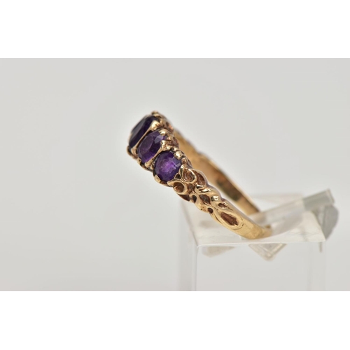 270 - A 9CT GOLD FIVE STONE AMETYHST RING, designed with a row of five graduated oval cut amethyst, scroll... 