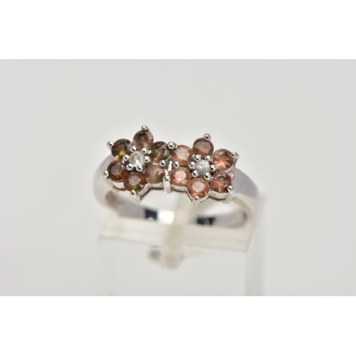 274 - A 9CT WHITE GOLD CLUSTER RING, designed with two flower shaped clusters, each set with a central col... 