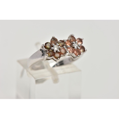 274 - A 9CT WHITE GOLD CLUSTER RING, designed with two flower shaped clusters, each set with a central col... 