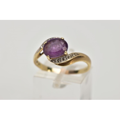 275 - A 9CT GOLD AMETHYST AND DIAMOND CROSS OVER RING, designed with a central oval cut amethyst, single c... 