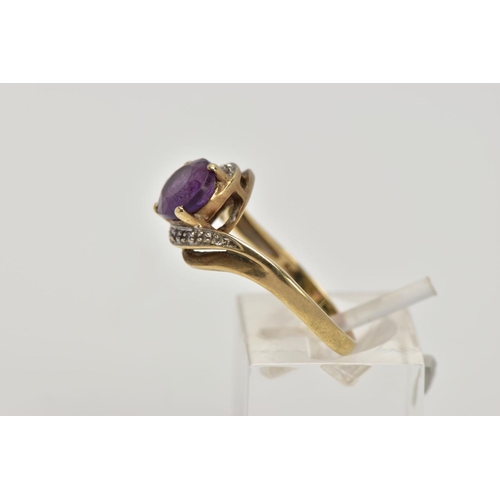 275 - A 9CT GOLD AMETHYST AND DIAMOND CROSS OVER RING, designed with a central oval cut amethyst, single c... 