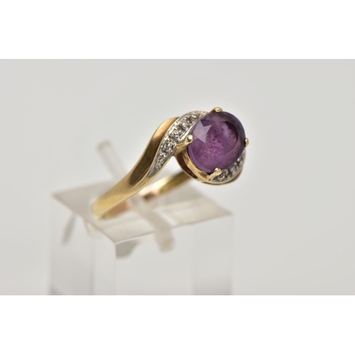 275 - A 9CT GOLD AMETHYST AND DIAMOND CROSS OVER RING, designed with a central oval cut amethyst, single c... 