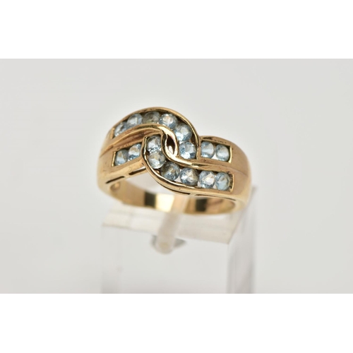 276 - A 9CT GOLD AQUAMARINE DRESS RING, of a crossover design, set with two rows of channel set circular c... 