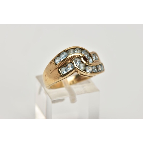 276 - A 9CT GOLD AQUAMARINE DRESS RING, of a crossover design, set with two rows of channel set circular c... 