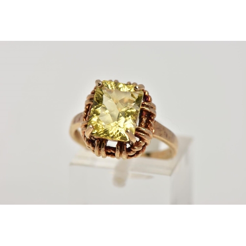 278 - A 9CT GOLD DRESS RING, designed with a claw set rectangular cut stone assessed as citrine, rope twis... 