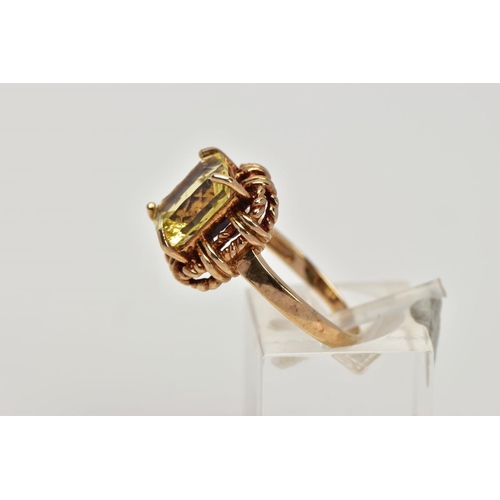 278 - A 9CT GOLD DRESS RING, designed with a claw set rectangular cut stone assessed as citrine, rope twis... 