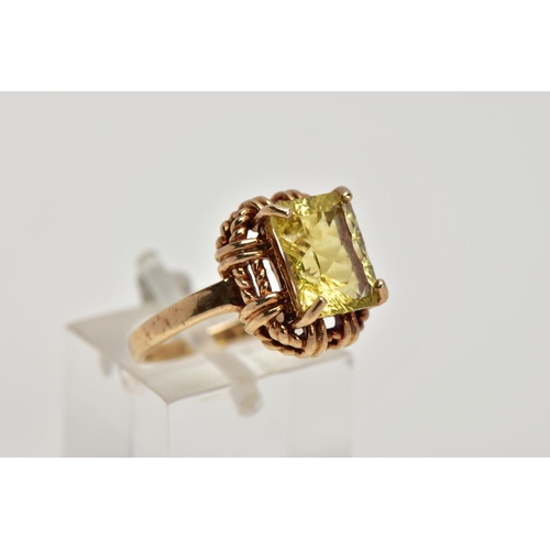 278 - A 9CT GOLD DRESS RING, designed with a claw set rectangular cut stone assessed as citrine, rope twis... 