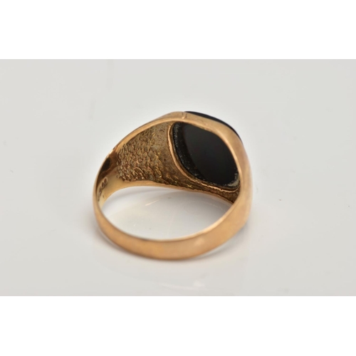 284 - A GENTS 9CT GOLD SIGNET RING, set with a rounded rectangular cut onyx, plain polished band, hallmark... 