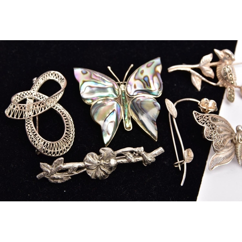 305 - SEVEN WHITE METAL BROOCHES, to include a marcasite flower stamped 'Sterling silver', an abalone shel... 