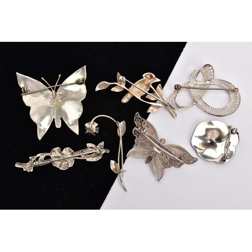 305 - SEVEN WHITE METAL BROOCHES, to include a marcasite flower stamped 'Sterling silver', an abalone shel... 