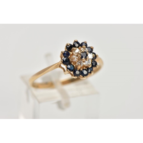 343 - A 9CT GOLD SAPPHIRE AND CUBIC ZIRCONIA CLUSTER RING, raised cluster set with a central circular cut ... 