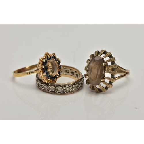 357 - A 9CT GOLD DRESS RING AND TWO YELLOW METAL RINGS, the first of an oval shape set with an oval cut sm... 