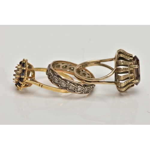 357 - A 9CT GOLD DRESS RING AND TWO YELLOW METAL RINGS, the first of an oval shape set with an oval cut sm... 