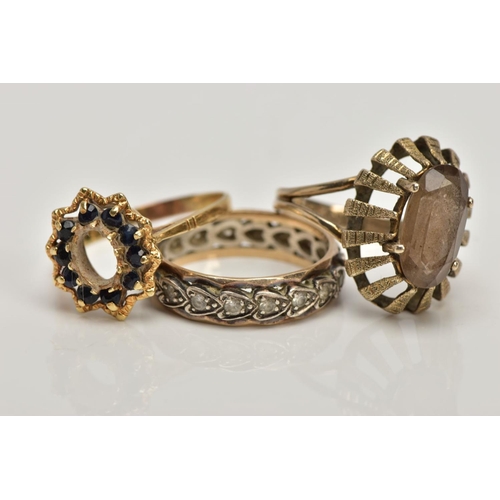 357 - A 9CT GOLD DRESS RING AND TWO YELLOW METAL RINGS, the first of an oval shape set with an oval cut sm... 