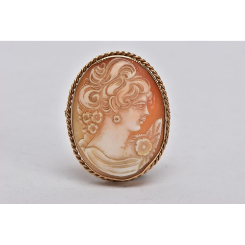 358 - A YELLOW METAL CAMEO BROOCH, of an oval form, depicting a lady in profile, within a collet mount and... 