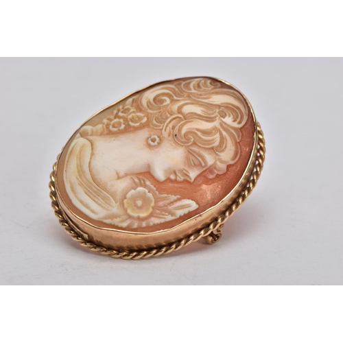 358 - A YELLOW METAL CAMEO BROOCH, of an oval form, depicting a lady in profile, within a collet mount and... 