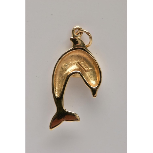 363 - A YELLOW METAL DOLPHIN PENDANT, fitted with a suspension ring, stamped to the reverse '14k', length ... 