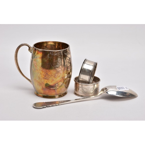 365 - A SILVER CHRSTENING CUP, SILVER TABLESPOON, AND TWO SILVER NAPKIN RINGS, plain polished gilt, bell-s... 