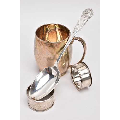 365 - A SILVER CHRSTENING CUP, SILVER TABLESPOON, AND TWO SILVER NAPKIN RINGS, plain polished gilt, bell-s... 