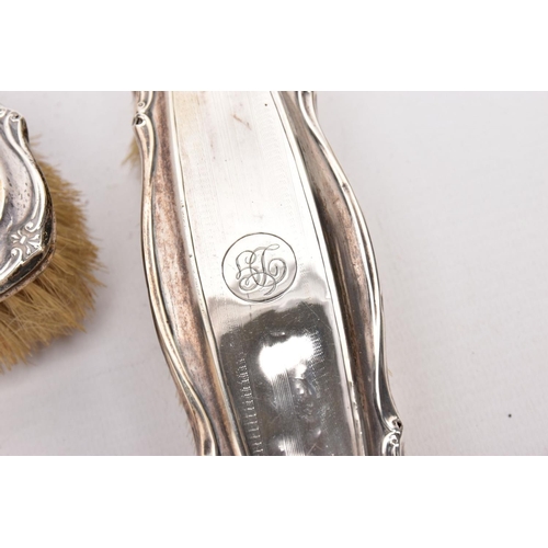 379 - A THREE-PIECE SILVER VANITY SET A BUTTON HOOK AND A SHOEHORN, the vanity set comprising of a hairbru... 