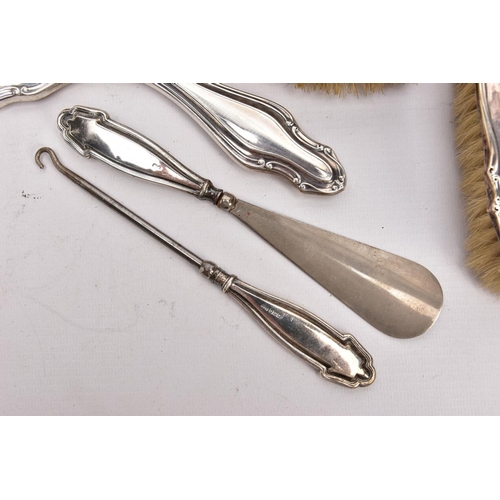 379 - A THREE-PIECE SILVER VANITY SET A BUTTON HOOK AND A SHOEHORN, the vanity set comprising of a hairbru... 