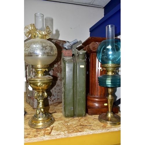 428 - SEVEN ITEMS, comprising a pair of wooden column pedestals, military marked petrol can, two oil lamps... 