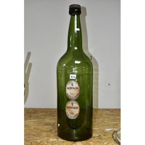 429 - A LARGE GLASS GUINNESS ADVERTISING BOTTLE, with labels 'Extra Stout  Guinness, Dublin & London', hei... 