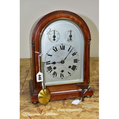 446 - AN EARLY 20TH CENTURY MAHOGANY CASED DOME TOP MANTEL CLOCK, silver coloured arched dial with slow/fa... 