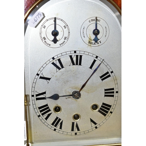 446 - AN EARLY 20TH CENTURY MAHOGANY CASED DOME TOP MANTEL CLOCK, silver coloured arched dial with slow/fa... 