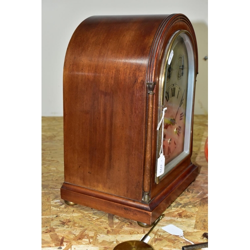 446 - AN EARLY 20TH CENTURY MAHOGANY CASED DOME TOP MANTEL CLOCK, silver coloured arched dial with slow/fa... 