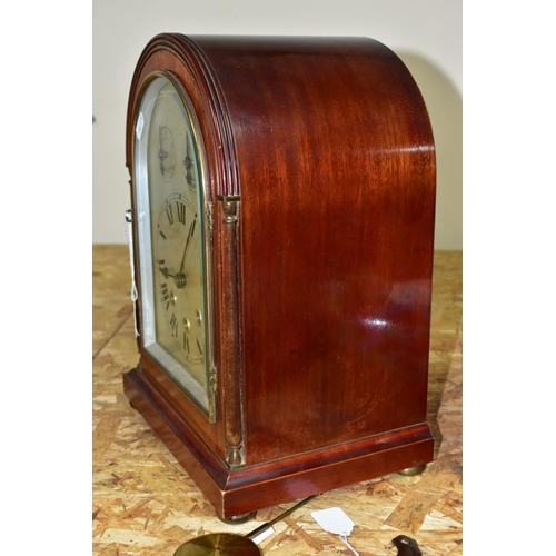 446 - AN EARLY 20TH CENTURY MAHOGANY CASED DOME TOP MANTEL CLOCK, silver coloured arched dial with slow/fa... 