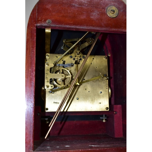 446 - AN EARLY 20TH CENTURY MAHOGANY CASED DOME TOP MANTEL CLOCK, silver coloured arched dial with slow/fa... 