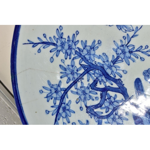 501 - A LATE 19TH CENTURY JAPANESE PORCELAIN CHARGER, blue and white decoration of an exotic bird amongst ... 