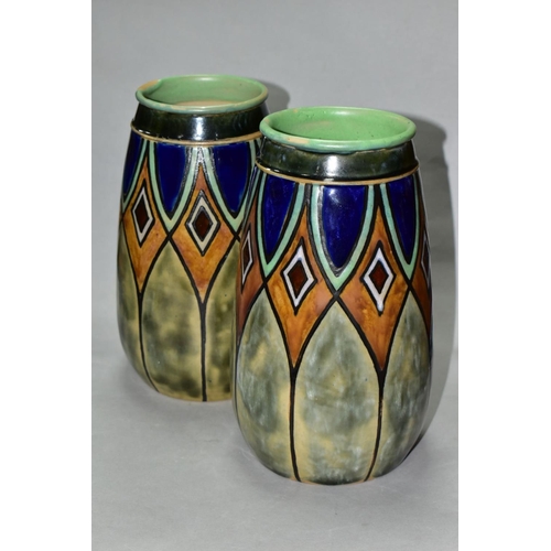 502 - A PAIR OF EARLY 20TH CENTURY ROYAL DOULTON STONEWARE BALUSTER VASES, incised and glazed with geometr... 