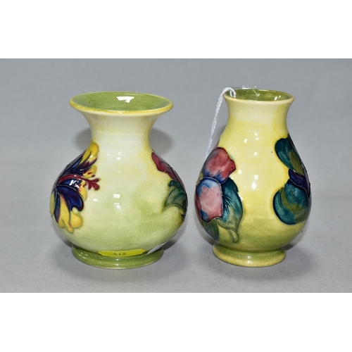 512 - TWO SMALL MOORCROFT POTTERY VASES, comprising a baluster shaped vase in Clematis pattern with purple... 