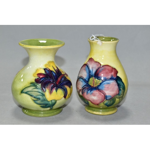 512 - TWO SMALL MOORCROFT POTTERY VASES, comprising a baluster shaped vase in Clematis pattern with purple... 