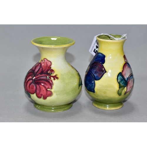 512 - TWO SMALL MOORCROFT POTTERY VASES, comprising a baluster shaped vase in Clematis pattern with purple... 