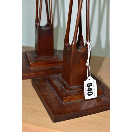 540 - A PAIR OF 20TH CENTURY MAHOGANY AND STAINED CANDLESTICKS, square holder above four slender twisted o... 