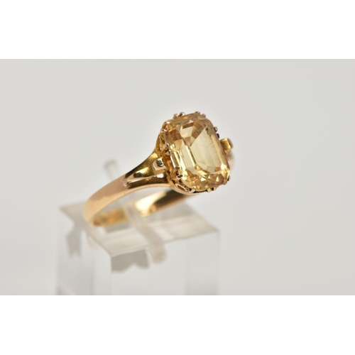 332 - A YELLOW METAL YELLOW TOPAZ RING, designed with a claw set, rectangular cut yellow topaz, scroll det... 