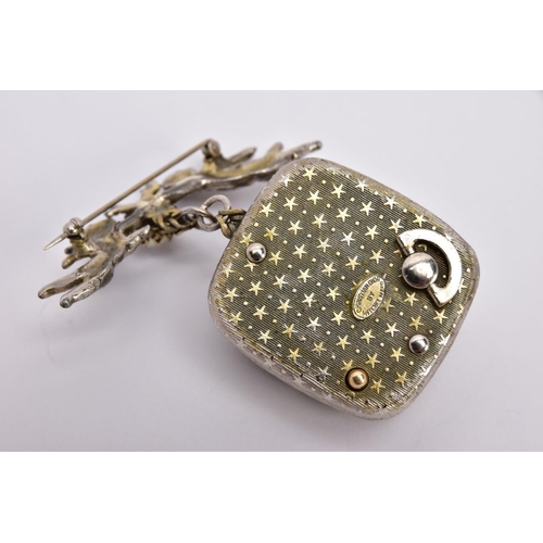 335 - A CHRISTIAN DIOR MUSICAL BROOCH, the rectangular musical box with central oval domes panel surround ... 