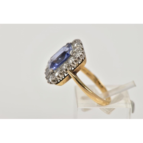 336 - A MID TO LATE 20TH CENTURY SAPPHIRE AND DIAMOND CLUSTER RING, an emerald cut purplish blue sapphire,... 