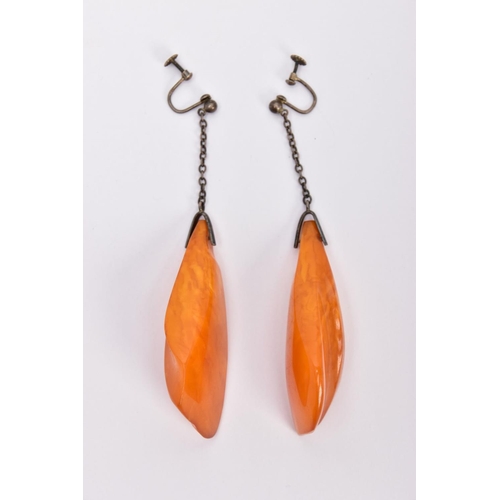 337 - A PAIR OF NATURAL AMBER EARRINGS, the large drop earrings each of a tapered outline suspended from a... 