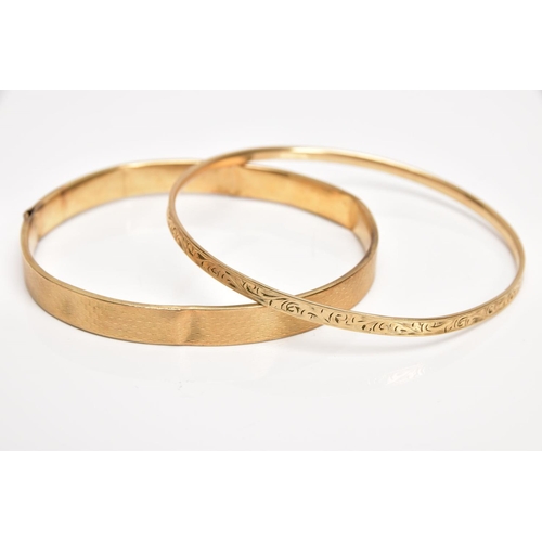 36 - A 9CT GOLD BANGLE AND A YELLOW METAL BANGLE, the first an AF bangle of an engine turned design, (spl... 