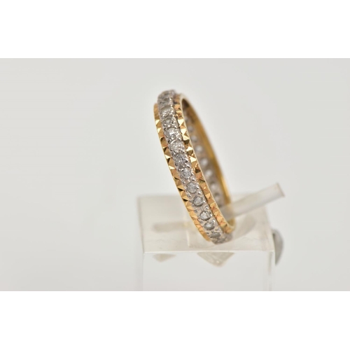 7 - A YELLOW METAL FULL ETERNITY RING, set with colourless spinels, textured gold rim, stamp mark unclea... 