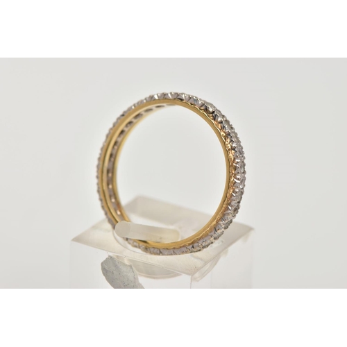 7 - A YELLOW METAL FULL ETERNITY RING, set with colourless spinels, textured gold rim, stamp mark unclea... 